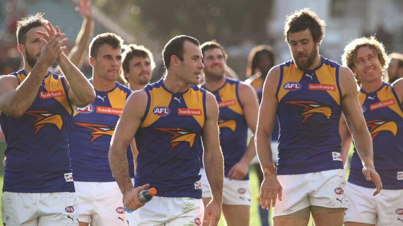 West Coast Eagles players walk from the field.