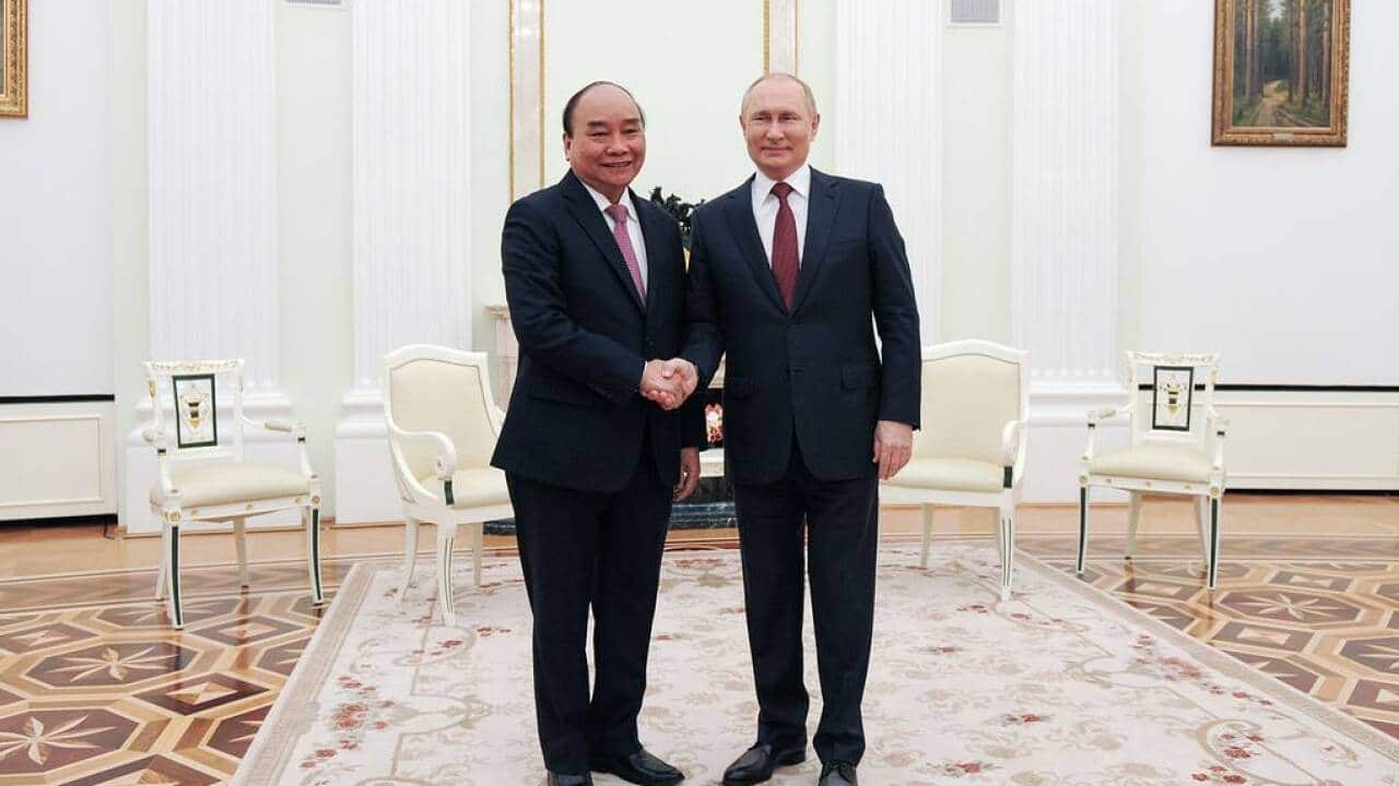 Russia's President Vladimir Putin (R) and Vietnam's President Nguyen Xuan Phuc shake hands during a meeting at Moscow's Kremlin.