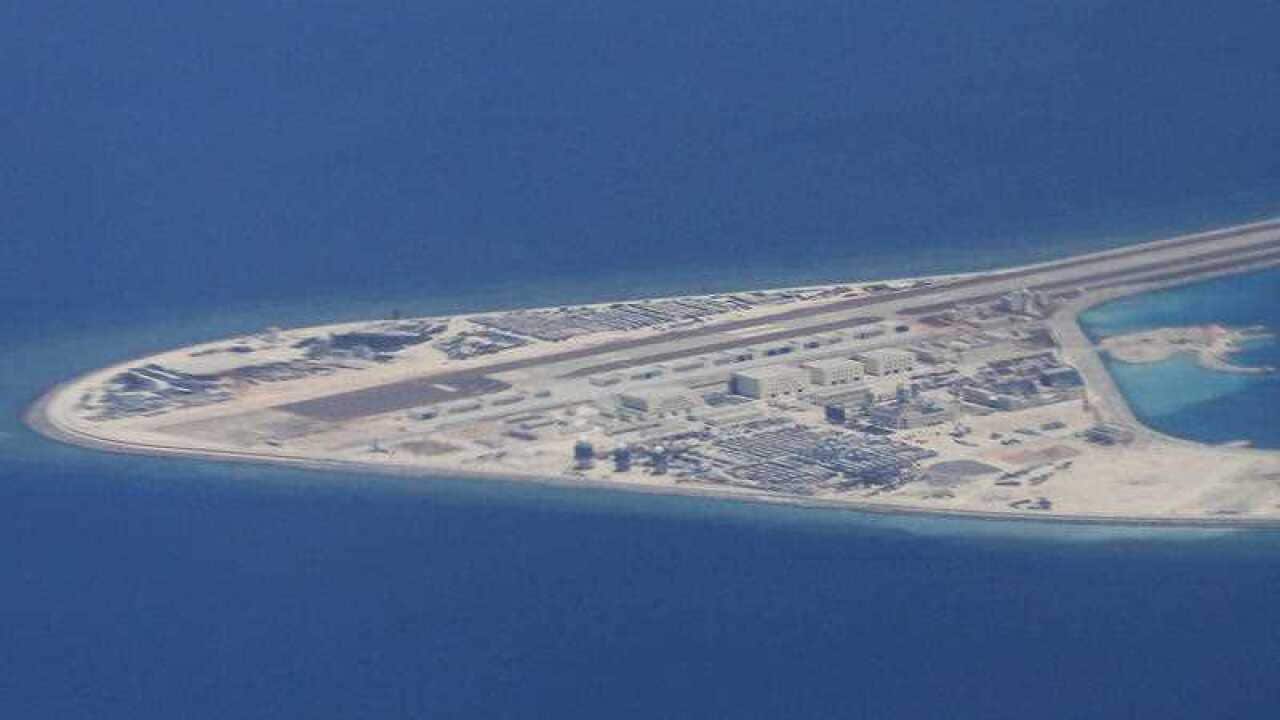 An airstrip, structures and buildings on China's man-made Subi Reef in the Spratly chain of islands in the South China Sea are seen from a Philippine Air Force plane.