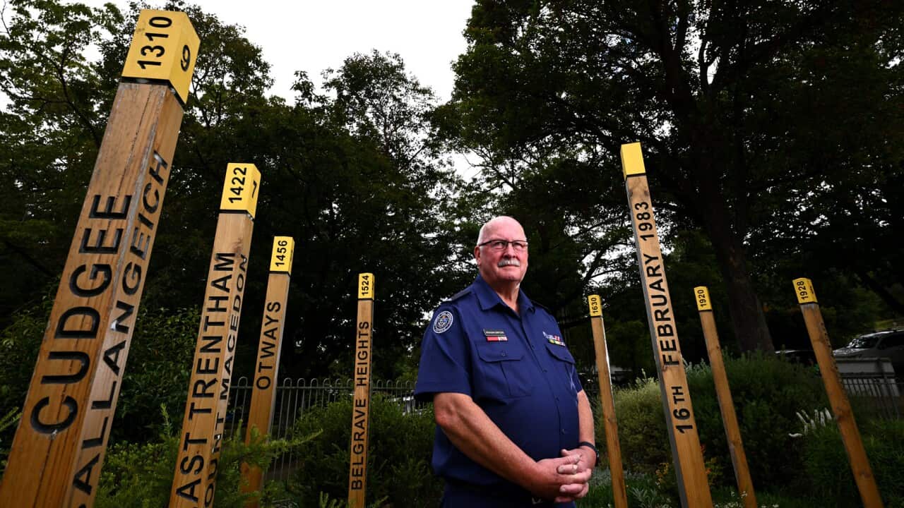 Former Cockatoo fire brigade captain poses with the Ash Wednesday memorial (AAP).jpg