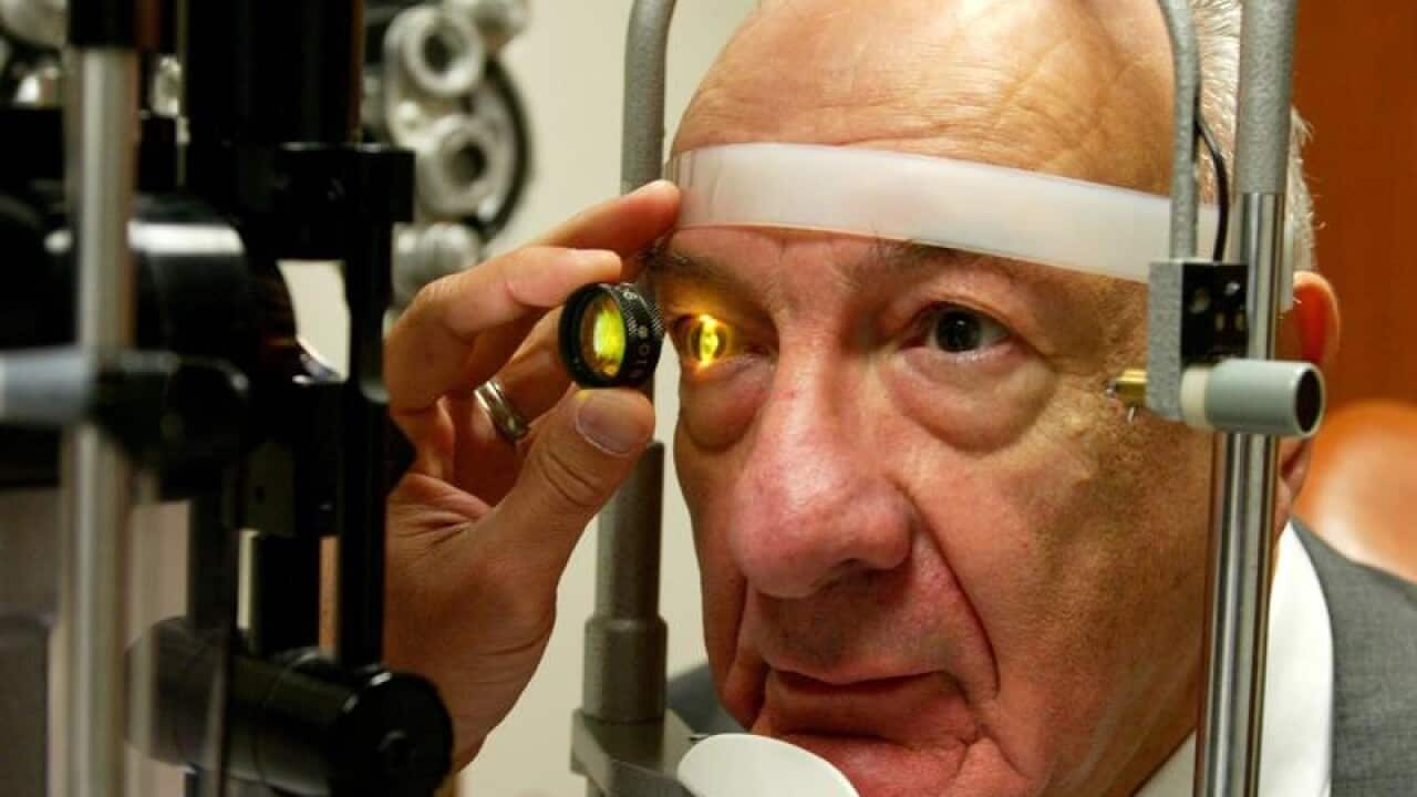 Ernest Hayeck has his eye's retina examined