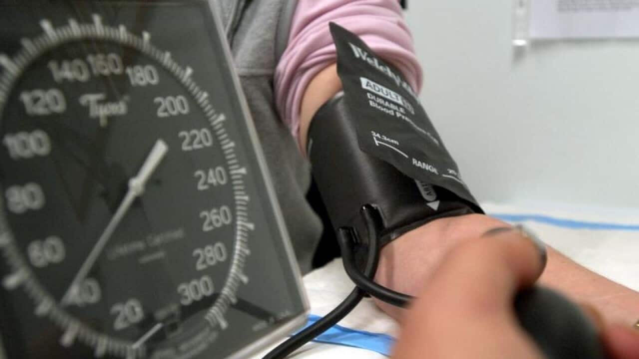 A patient has her blood pressure checked in Canberra