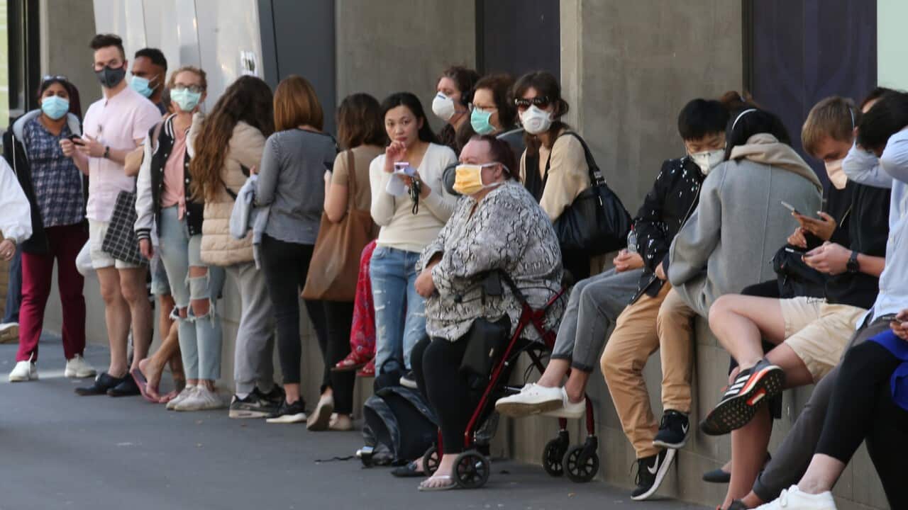 People line up outside the Royal Melbourne Hosital for coronavirus testing in Melbourne, Tuesday, March 10, 2020. (AAP Image/David Crosling) NO ARCHIVING