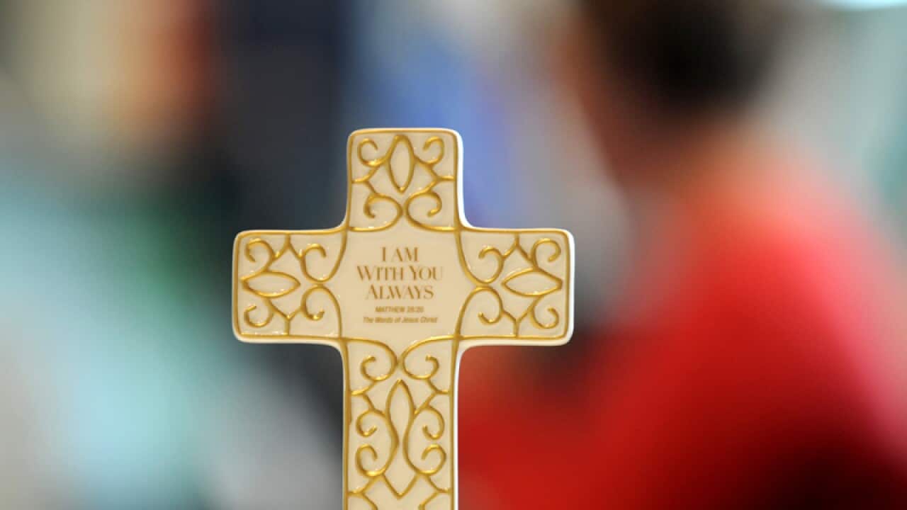 A cross, with the inscription 'I Am With You Always