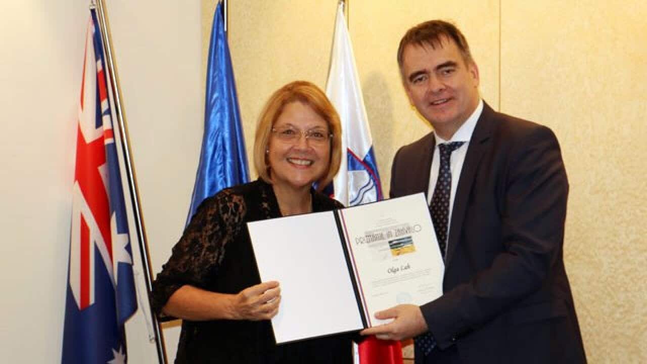 Olga Lah receiving the award from Slovenian Ambassador to Australia, Jurij Rifelj