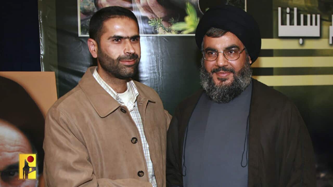 Wissam Hassan Tawil shakes hands with Hezbollah Secretary-General Sayed Hassan Nasrallah