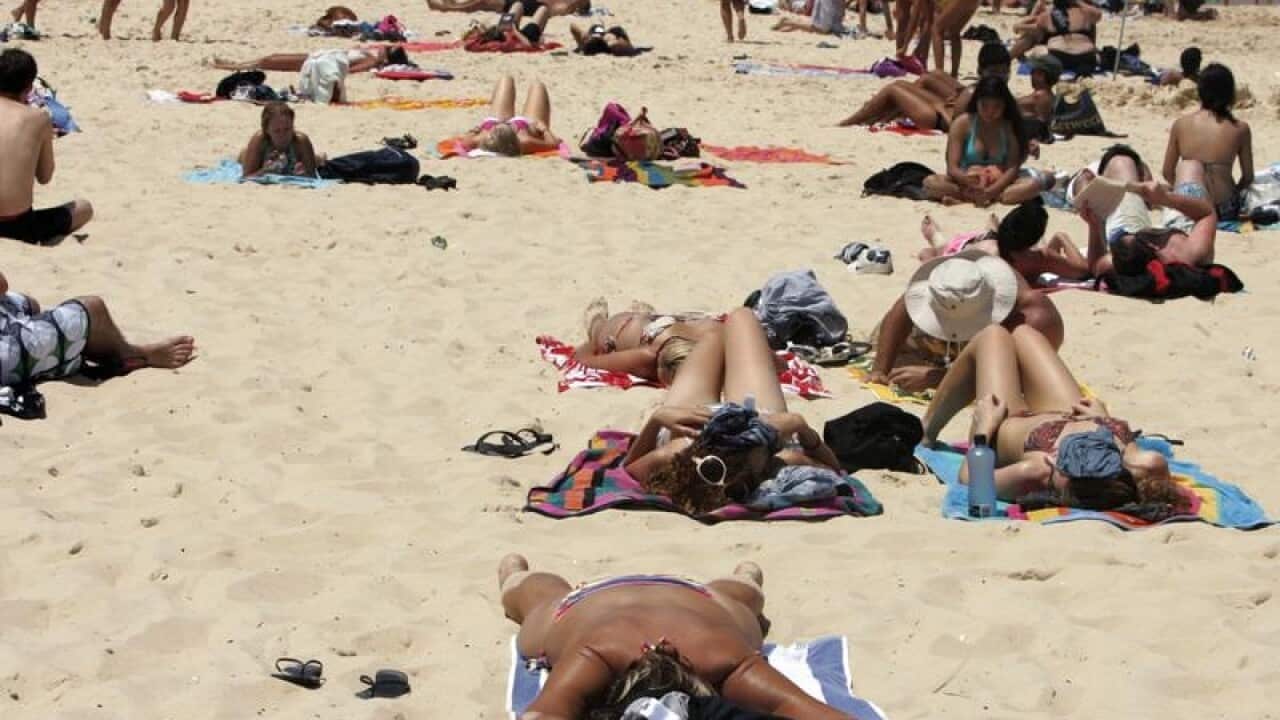 Beachgoers sunbathe at Bondi Beach in Sydney.