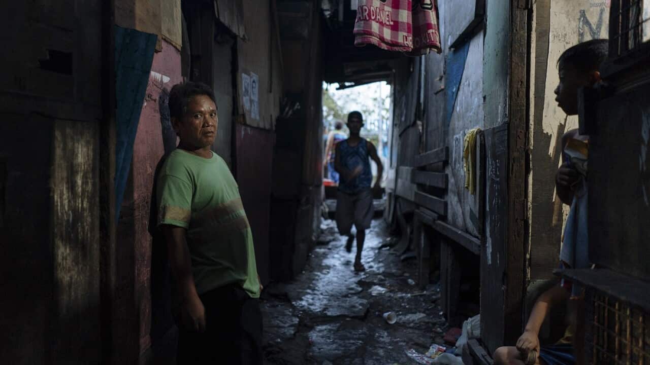 Edwin Panis in the alleyway of a slum near where he was seized in the Tondo district of Manila.