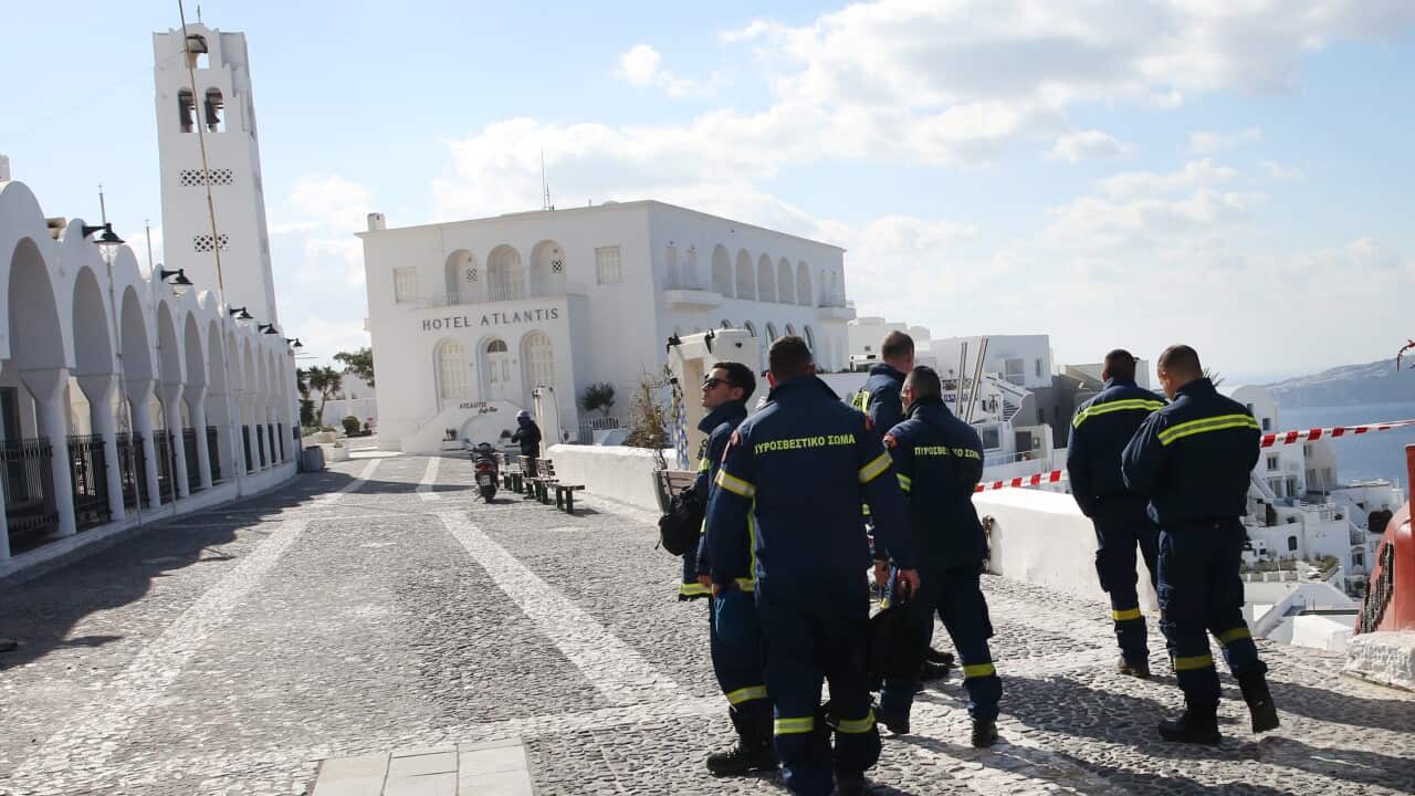 A group of emergency workers walking through a village.