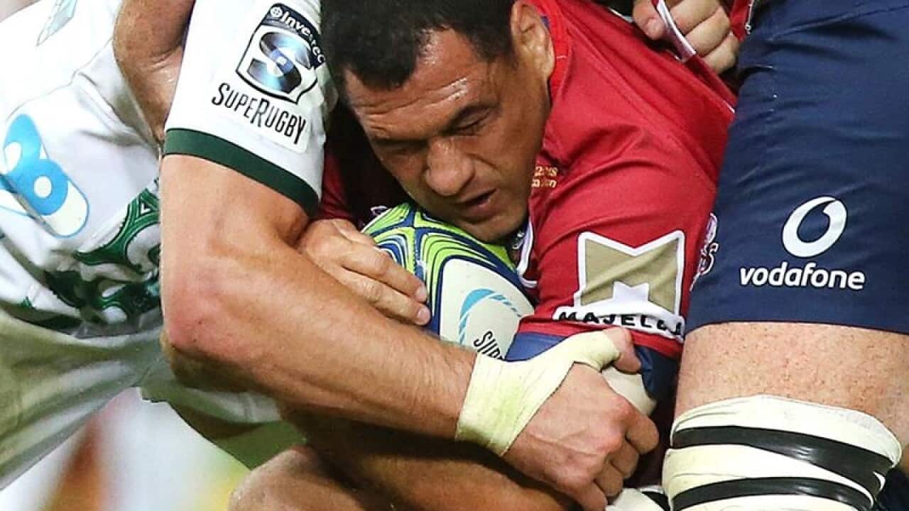 George Smith of the Queensland Reds is tackled by Chiefs players.