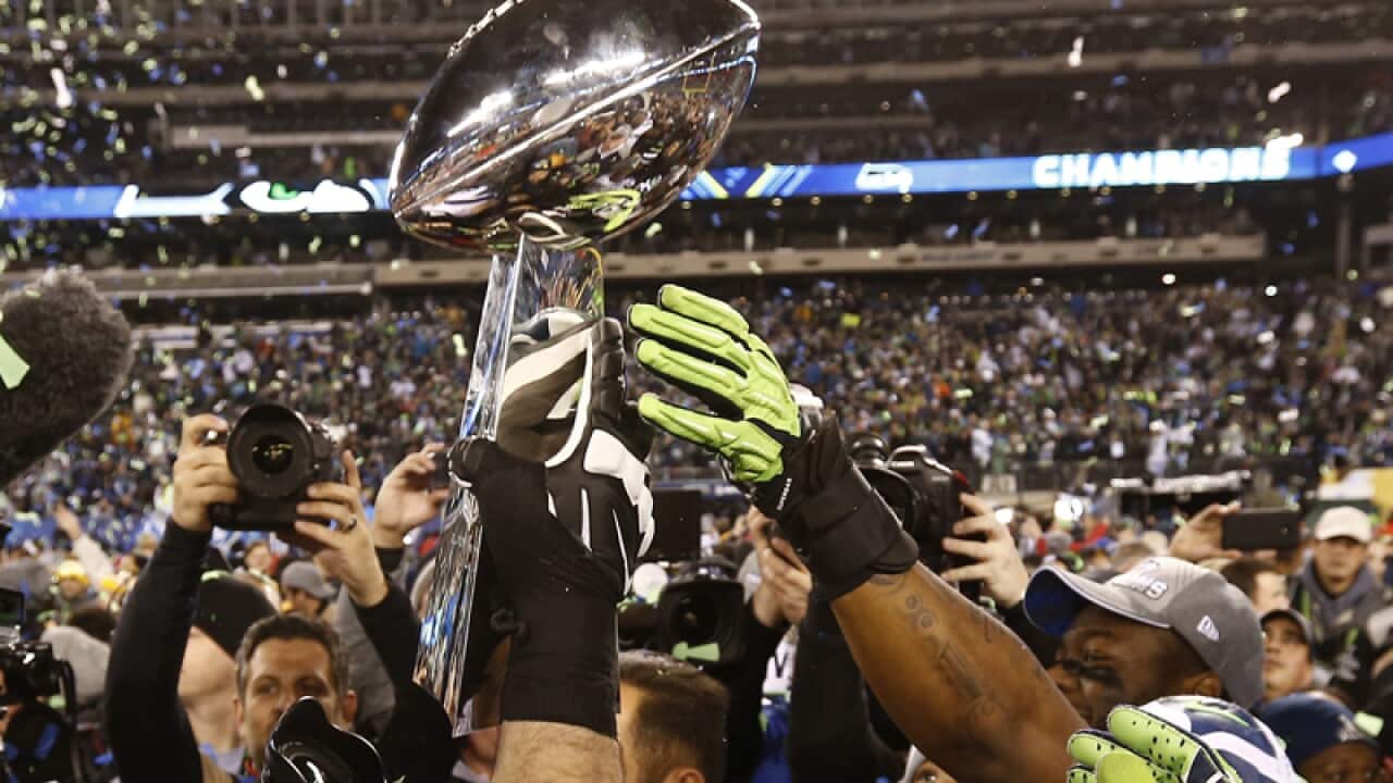 Seattle Seahawks reach for the Vince Lombardi Trophy