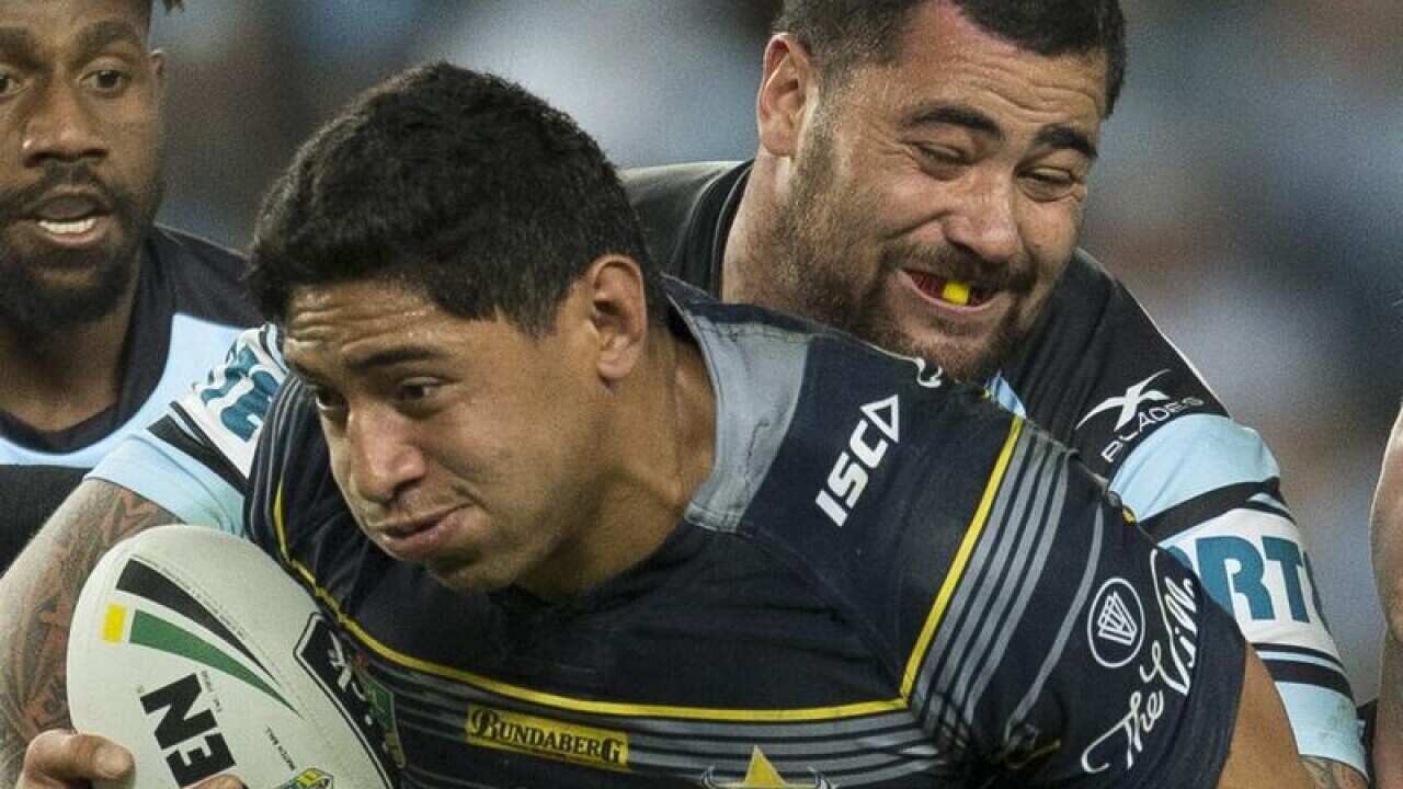 Jason Taumalolo of the Cowboys is tackled by Andrew Fifita