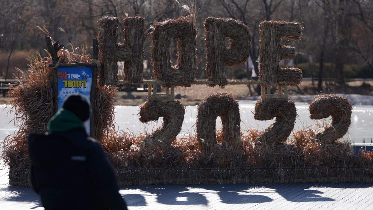 A man looks at the decorations for the coming 2022 Year on New Year's Eve in Seoul, South Korea, Friday, Dec. 31, 2021. (AP Photo/Lee Jin-man)