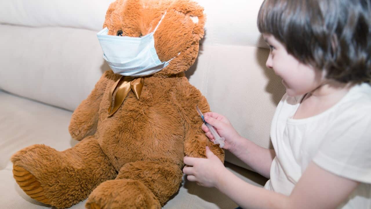The kid puts the vaccine for the toy.