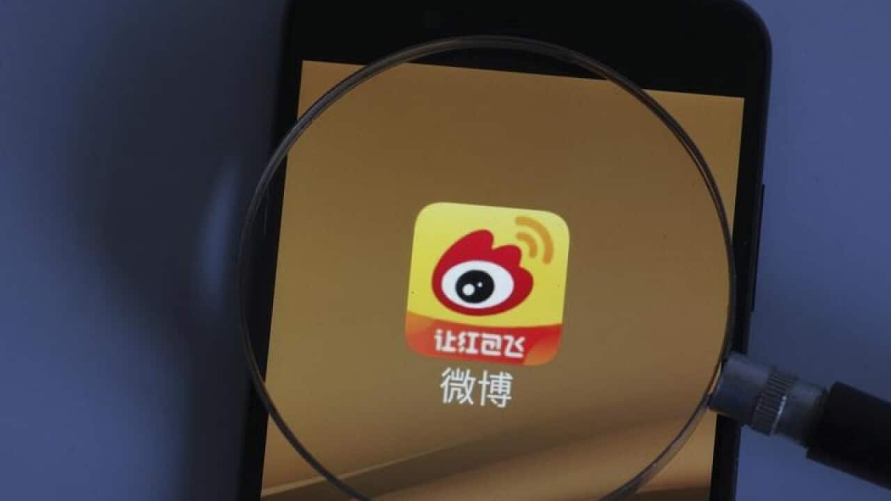 A mobile phone displaying Weibo