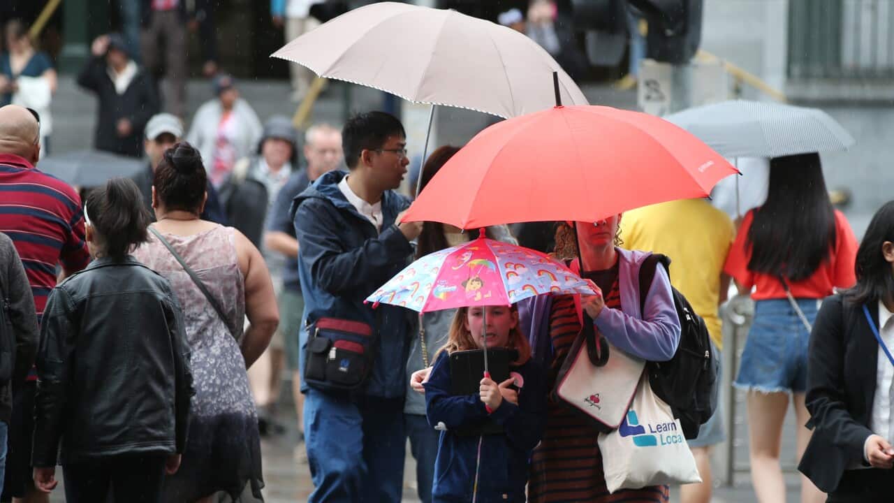 Pedestrians are seen during a rainy day in Melbourne.