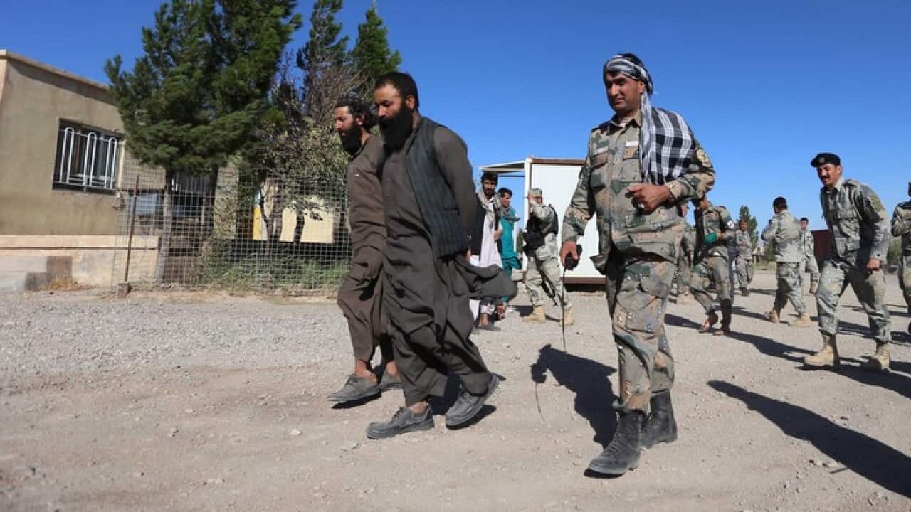 Afghan security officials and two alleged captured Taliban militants