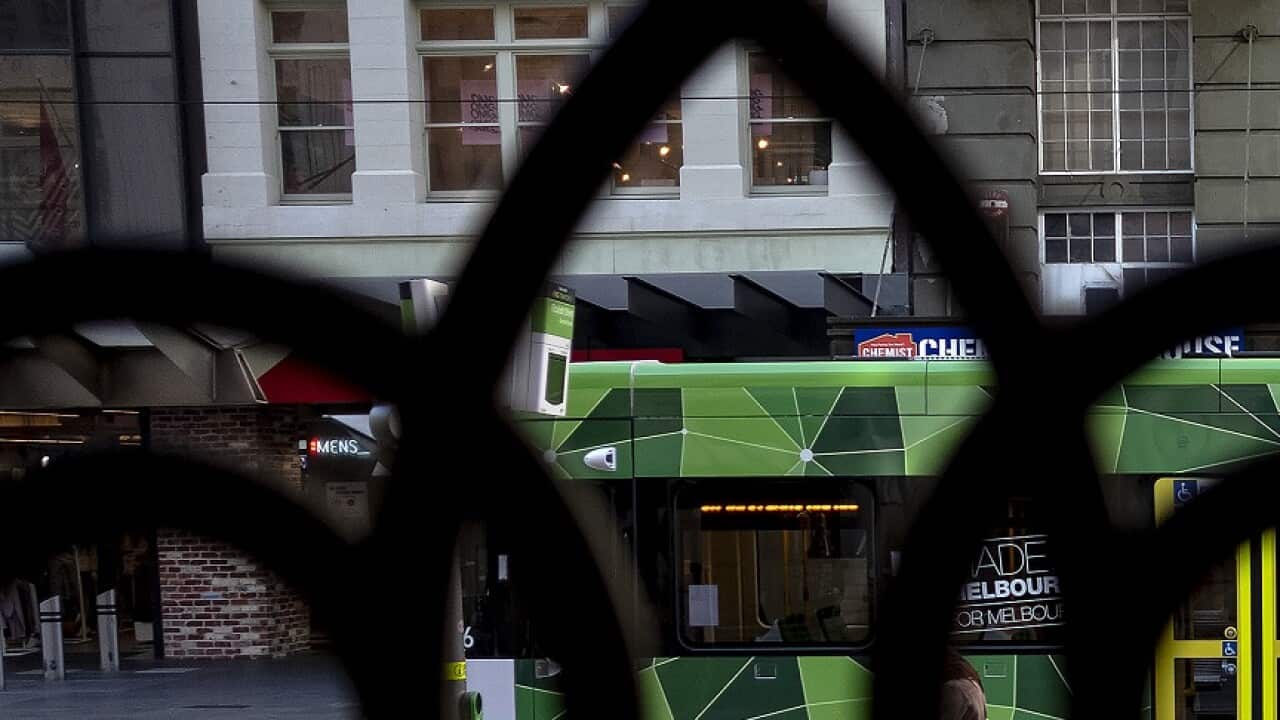 People wearing face masks are seen during a lockdown in Melbourne, Thursday, July 9, 2020. The Melbourne metropolitan area was put in locked down on Thursday in an effort to slow the spread of coronavirus. (AAP Image/Luis Ascui) NO ARCHIVING