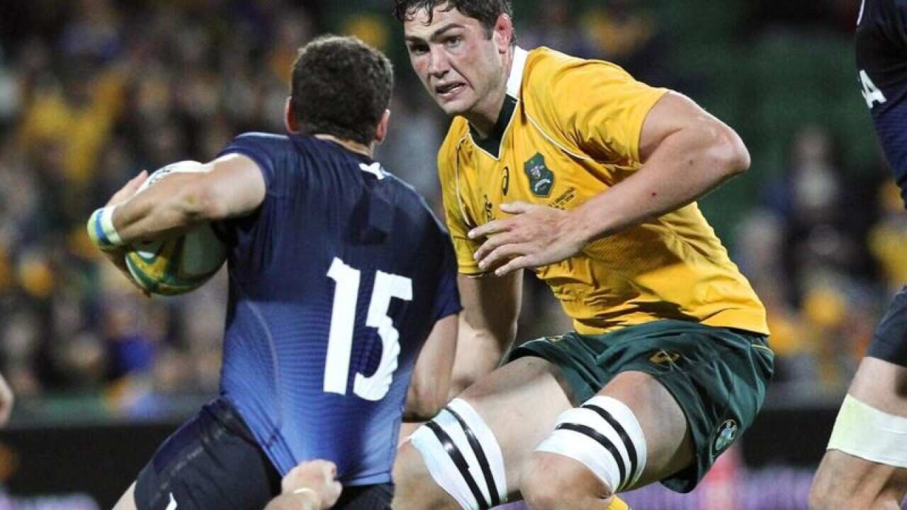 Rob Simmons of the Wallabies about to tackle JoaquAn Tumult