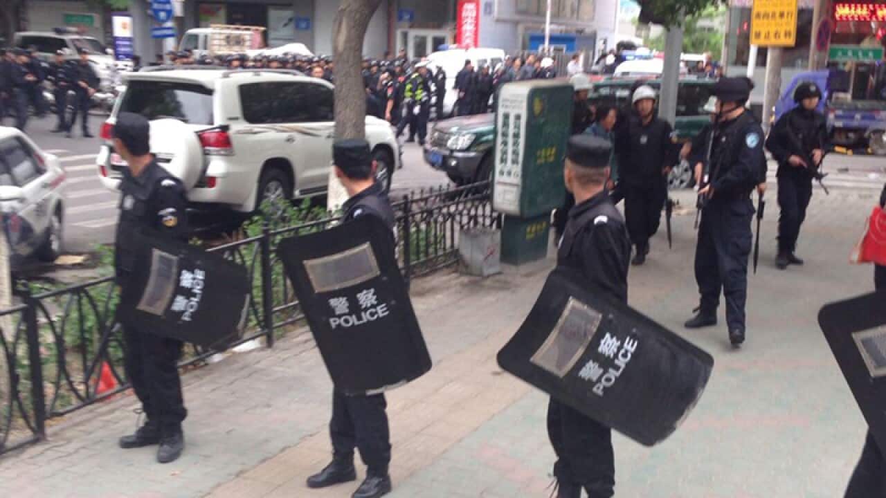 police officers stand guard near a blast site in downtown Urumqi