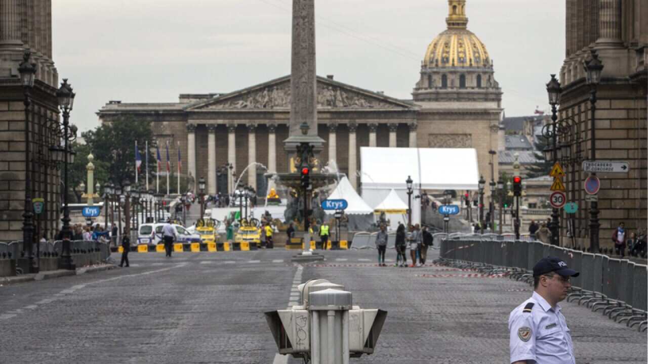 A police officer stands prior to the arrival of the Tour de France