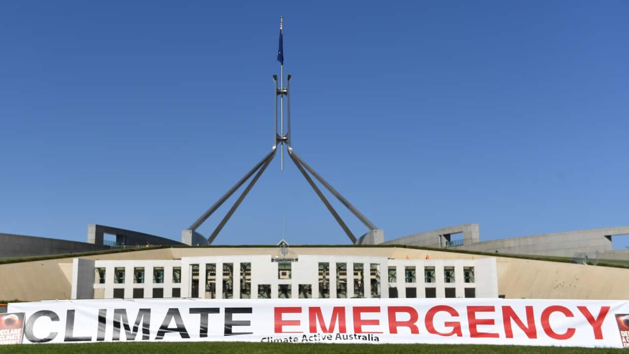 A climate emergency banner outside Parliament House in Canberra