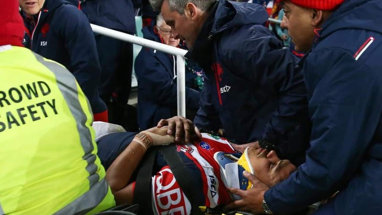 Latrell Mitchell of the Roosters is stretchered off the field.