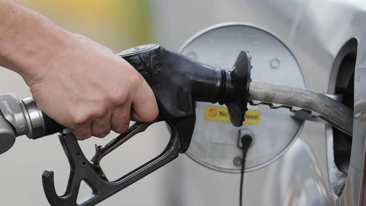File image of man pumping petrol at a service station