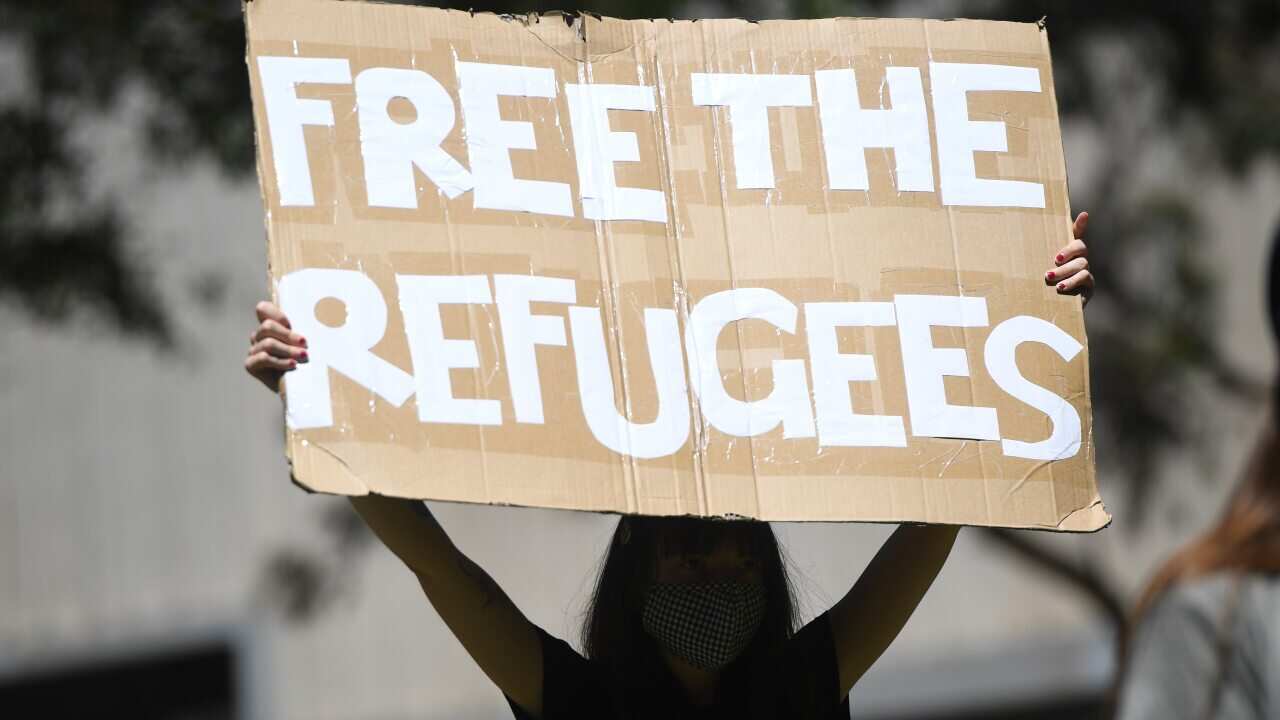 Protesters are seen outside the State Library of Victoria in Melbourne.