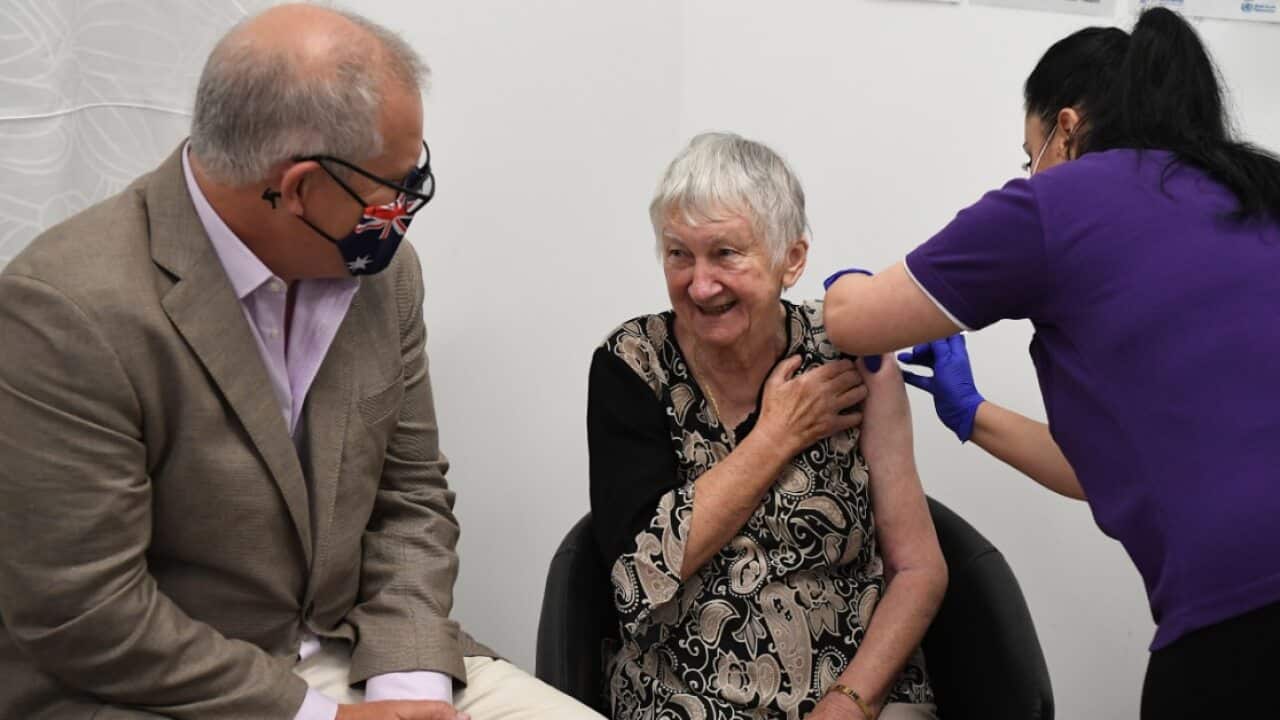 Prime Minister Scott Morrison joins Jane Malysiak (right) as she receives the first COVID-19 vaccine in Australia
