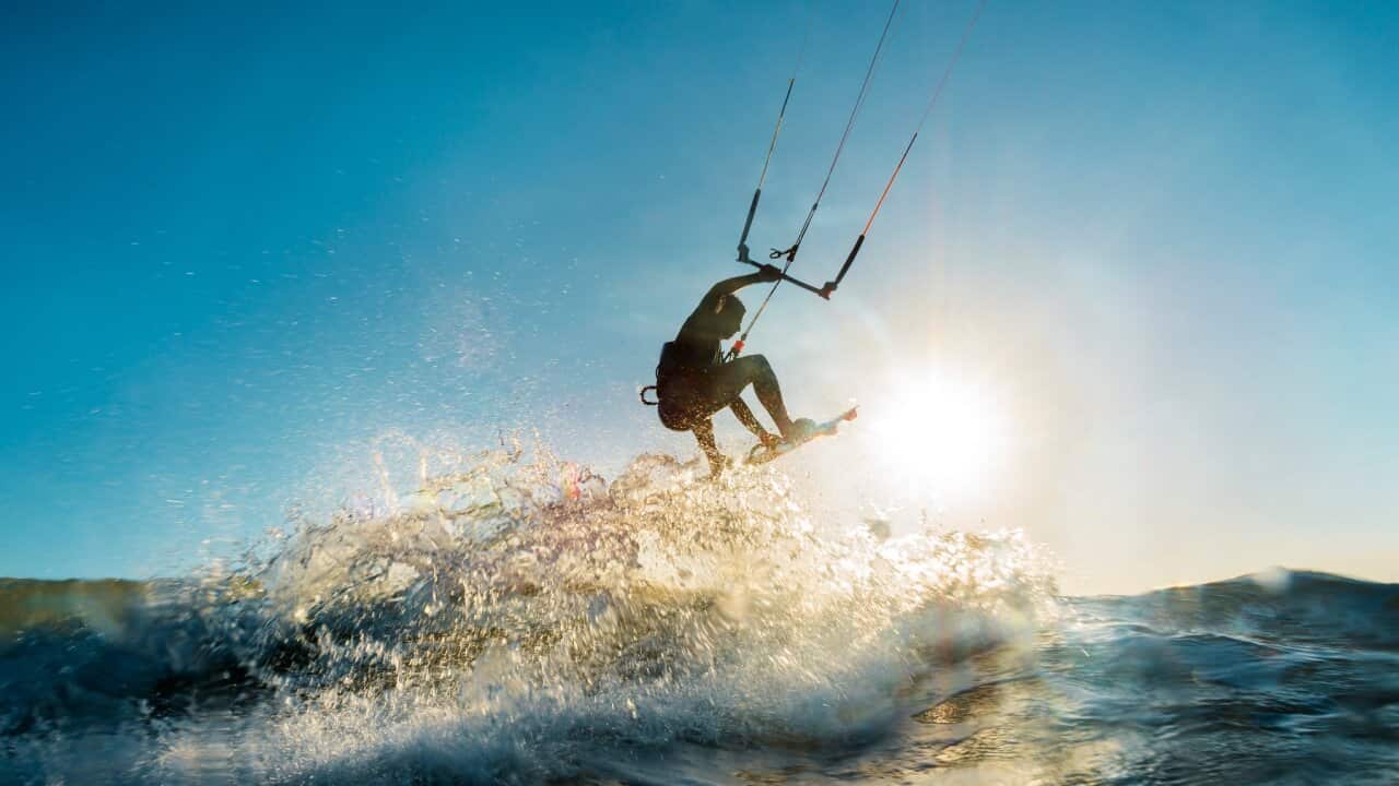 Surfer jumping at the sunset