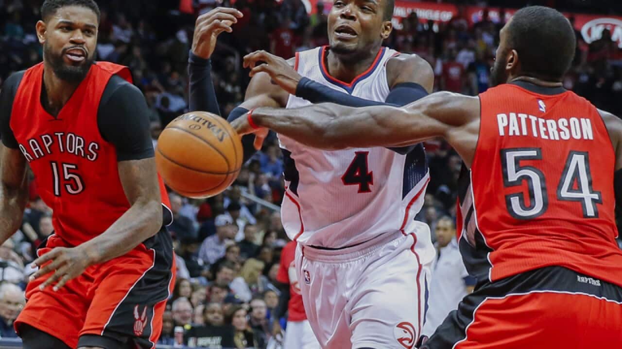 Raptors' Amir Johnson (L) and Patrick Patterson against Paul Millsap