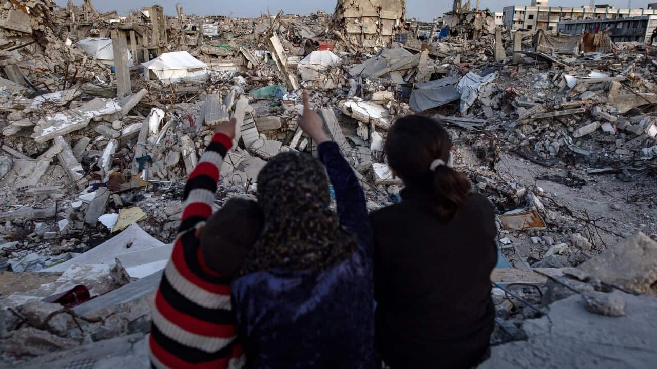 Children look out at the rubble in Gaza.
