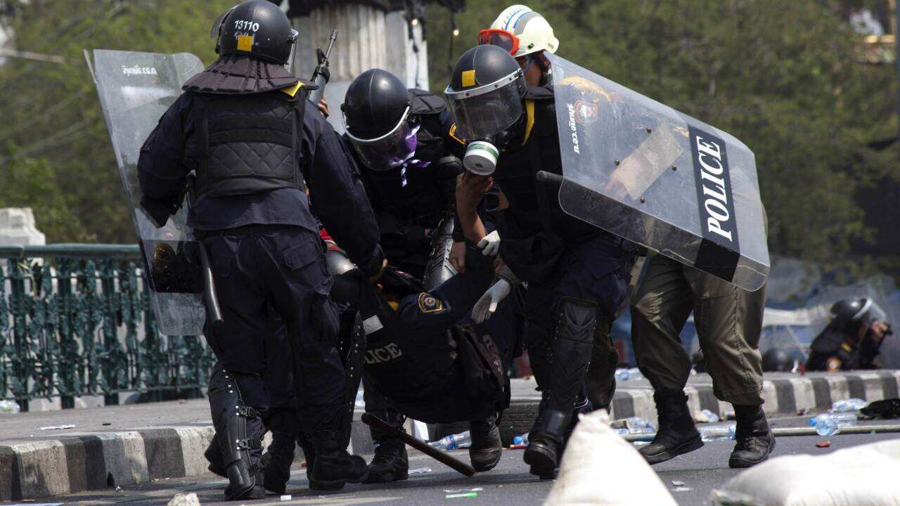 Thai police carry an injured colleague after a grenade was thrown into their ranks by anti-government protesters - AAP-1.jpg