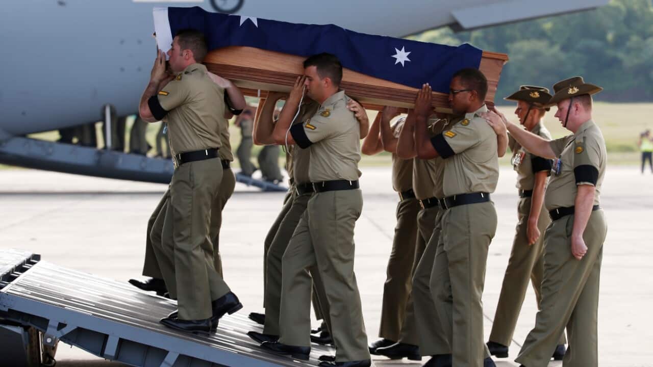 Australian military personnel carry coffins during a repatriation ceremony for Australian soldiers at Subang military air base in Kuala Lumpur, Malaysia,