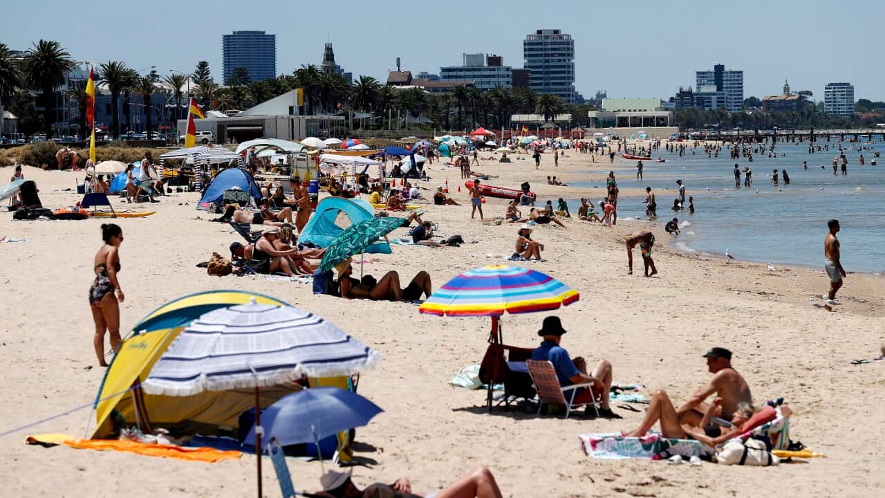 Beach goers are seen at Port Melbourne beach in Melbourne on 27 December 2022.