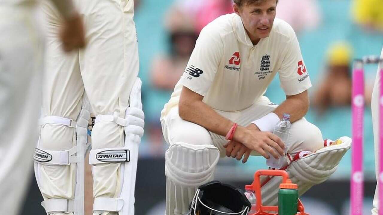 England's captain Joe Root squats as he takes a drinks break