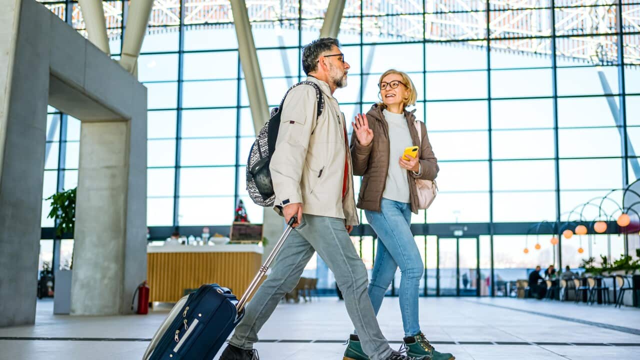 Mature couple of passengers at the train station
