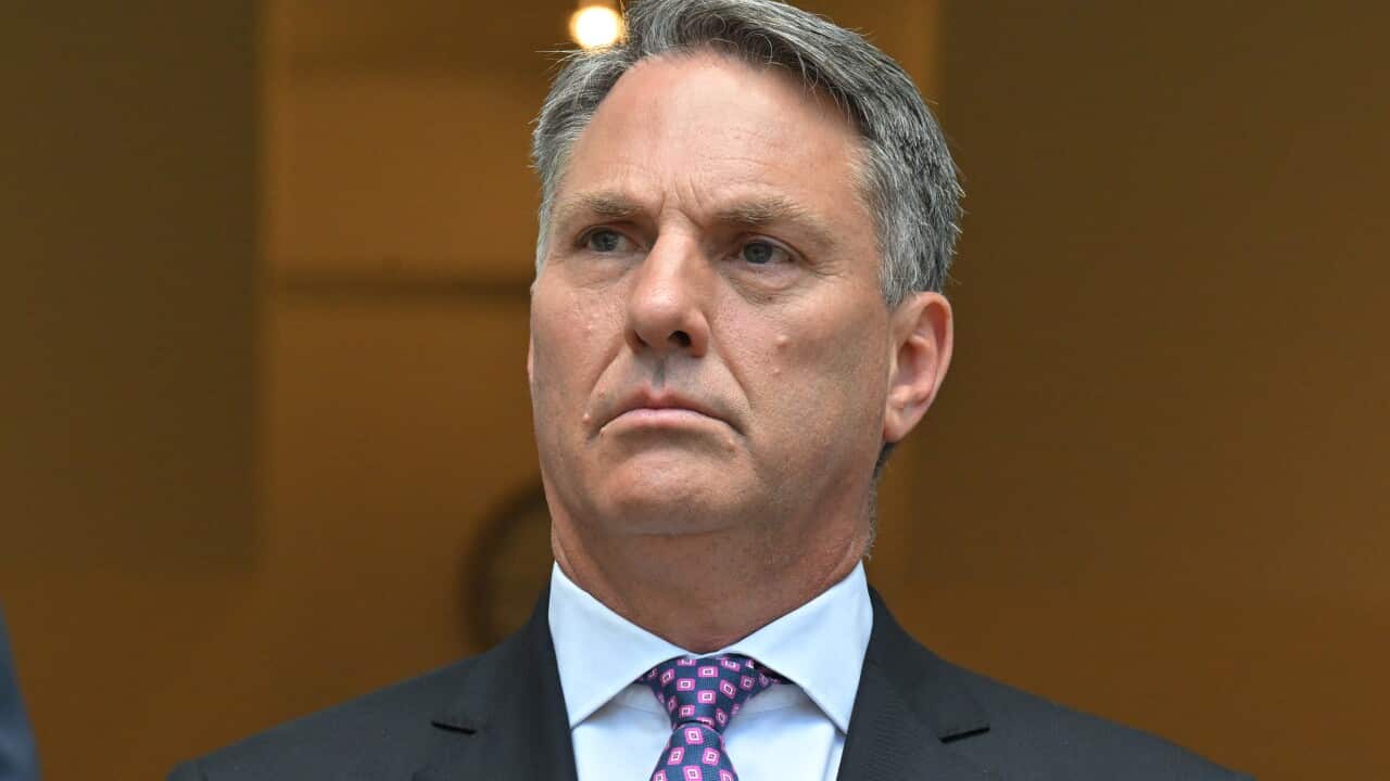 Richard Marles in a black blazer, white shirt and colourful tie.