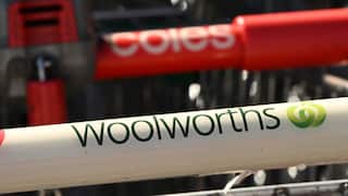 Woolworths and Coles trolleys next to each other.