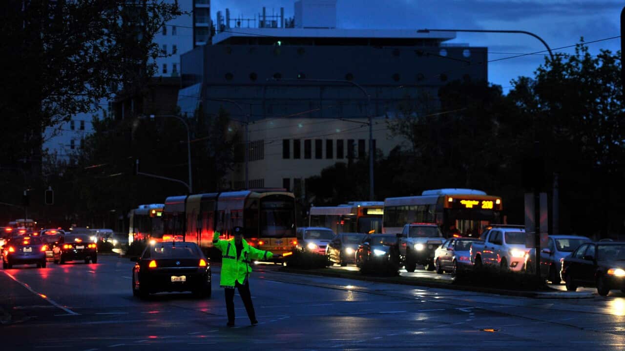 Police direct traffic around the CBD in Adelaide after the power stops working.