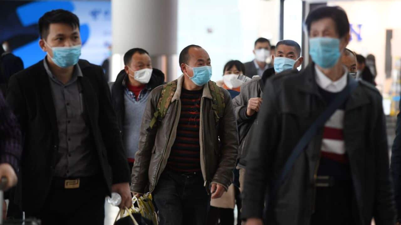 Passengers wear face masks as a preventive measure against the COVID-19 coronavirus as  they arrive from a domestic flight at Beijing Capital Airport 