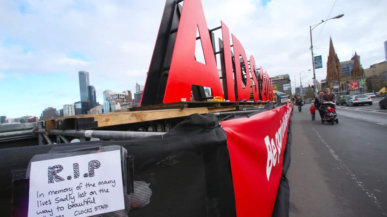 Flowers have been left by at a large sign on the Princes bridge in Melbourne for delegates who have been killed on flight MH17 who were traveling to the Aids 2014 conference. Saturday, July 19. 2014. (AAP)