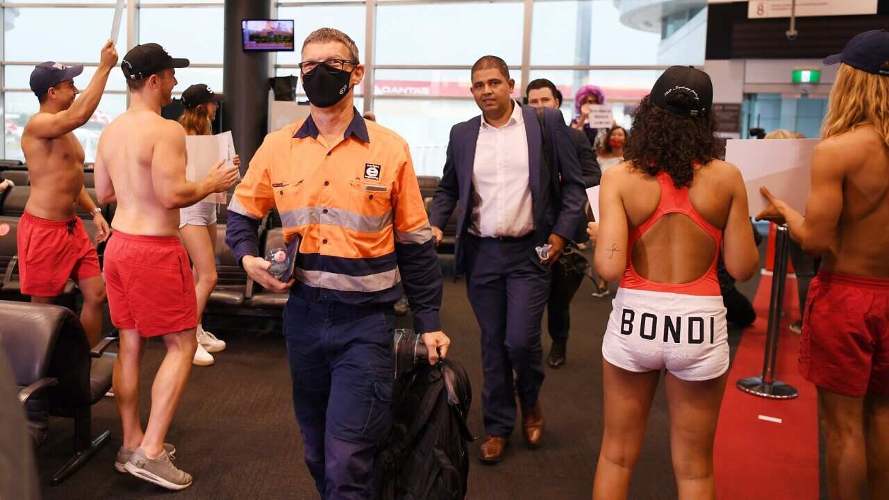 Passengers disembark the first Qantas flight from Melbourne following the lifting of border restrictions at Sydney Airport, Sydney,