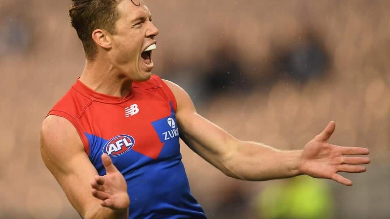 Jake Melksham of the Demons reacts after kicking a goal.