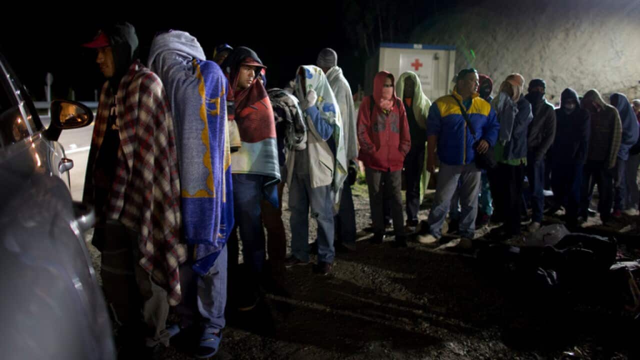 Venezuelan refugees line up for free bread and coffee in Pamplona, Colombia