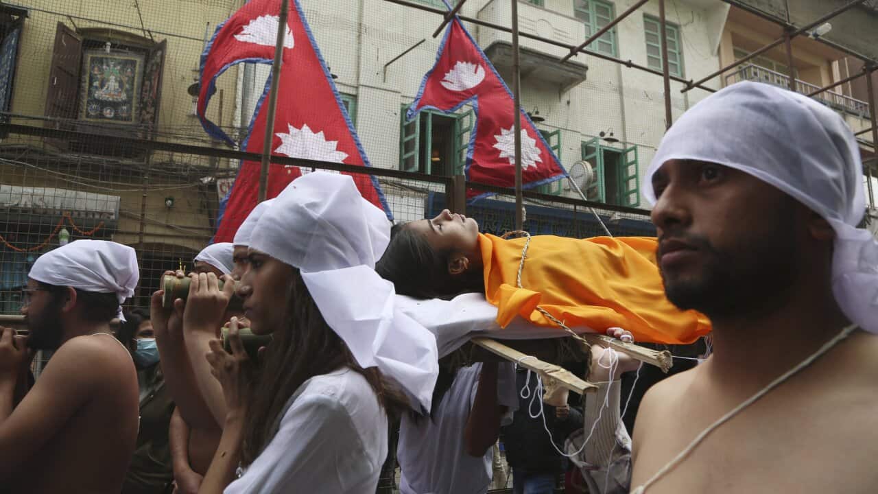 Nepal activists stage a mock Hindu funeral during a protest rally in Kathmandu, Nepal, Friday, Feb. 12, 2021.