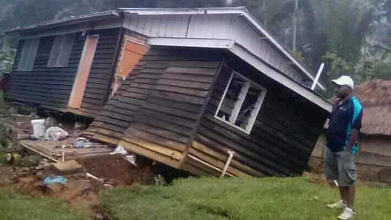 A man views a house that collapsed in a 2018 earthquake in Hela Province, Papua New Guinea