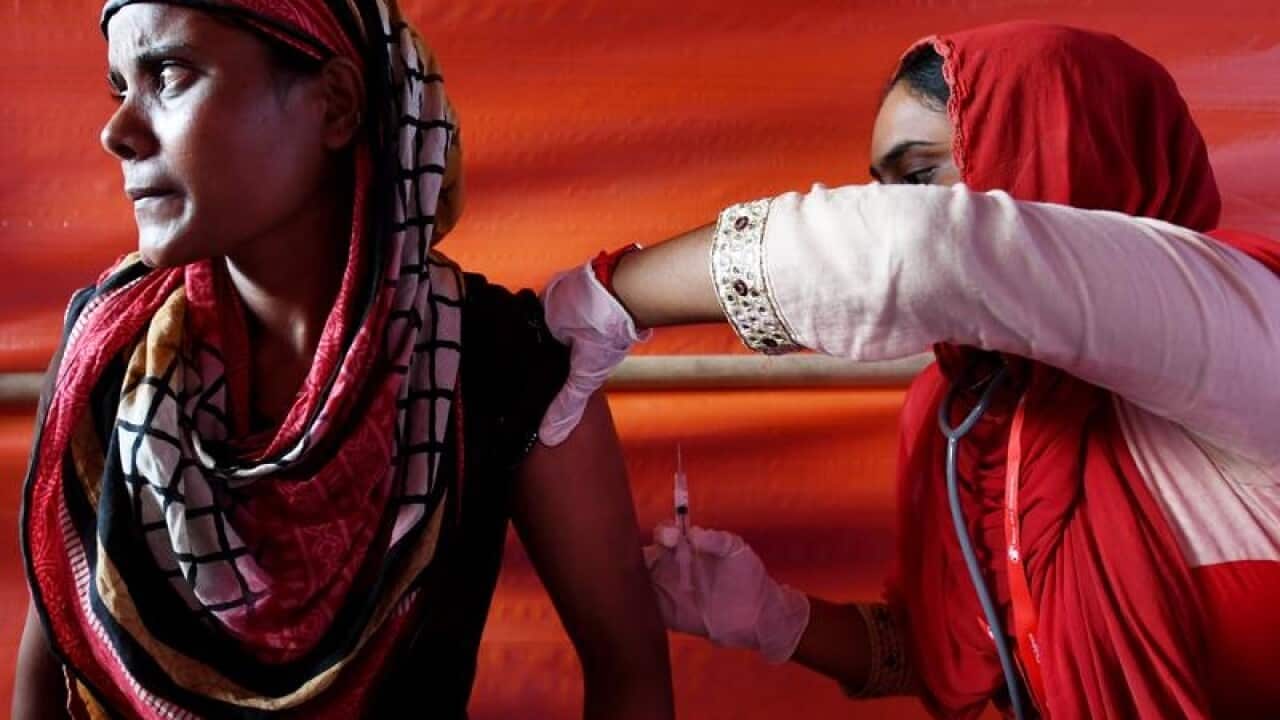 A file image of a Rohingya woman receiving a contraceptive injection.