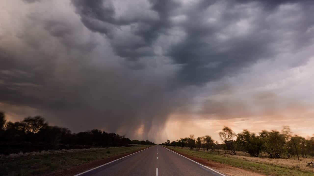 Empty highway heading towards a thunderstorm photographed in a remote part of Western Australia, Australia